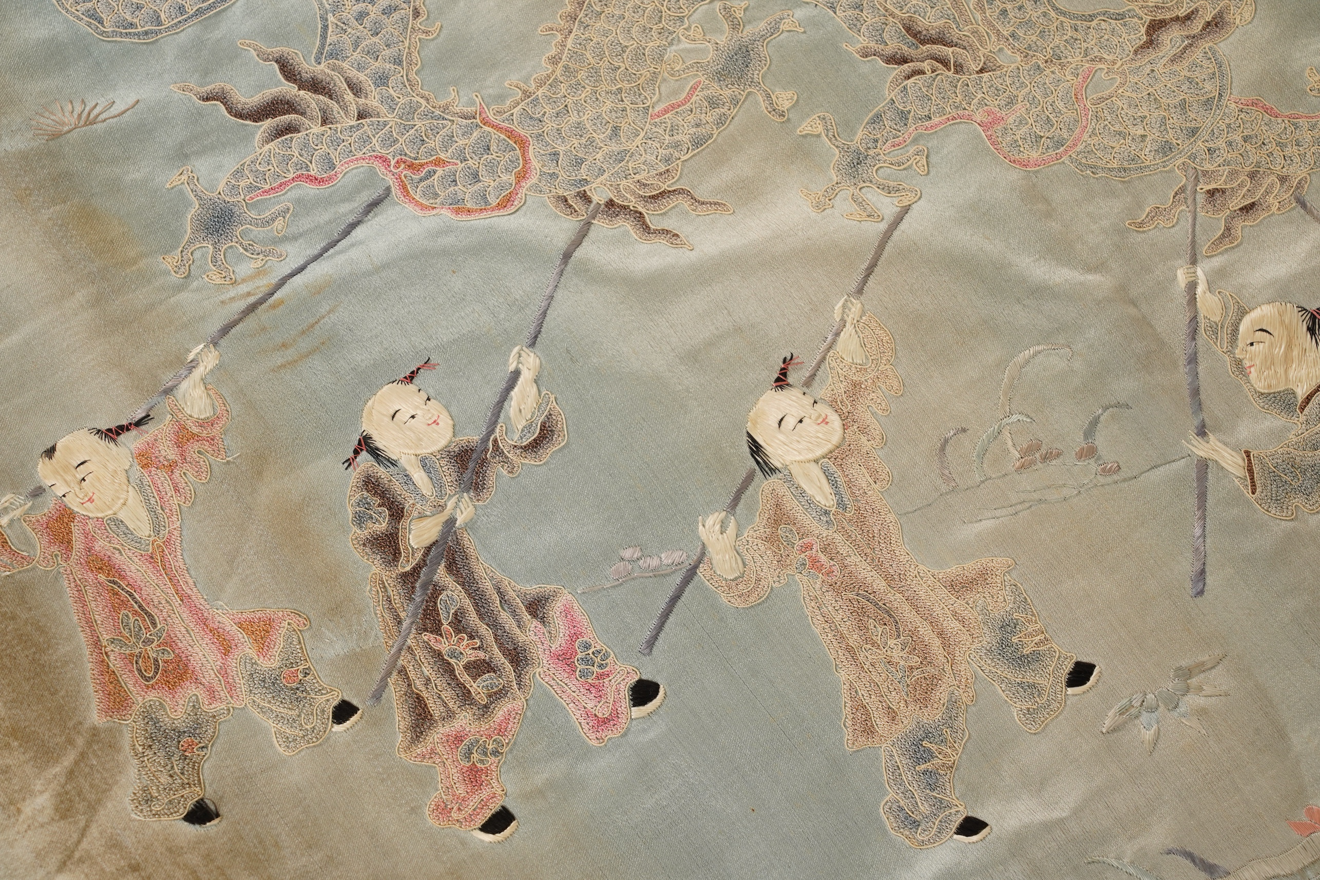 A Chinese embroidered silk ‘dragon dance’ panel, 18th/19th century